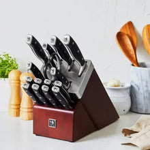 Self-sharpening knife block set with black-handled knives in red wooden block