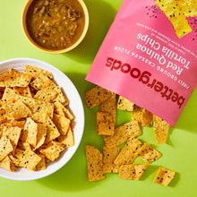 Red quinoa tortilla chips in bowl with bettergoods bag and scattered chips