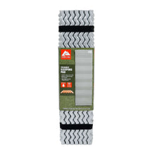 Foldable gray PE sleeping pad in packaging with black strap and zigzag texture