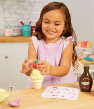 Pretend ice cream cone with sand scoop, held by a child wearing a pink dress