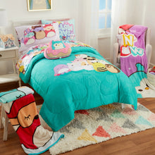 Teal kids fleece throw blanket with animal face print, draped on a bed