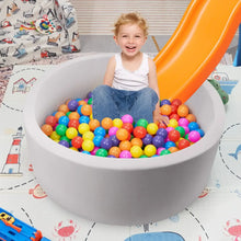 Gray foam ball pit with orange slide, round basin filled with multicolor play balls