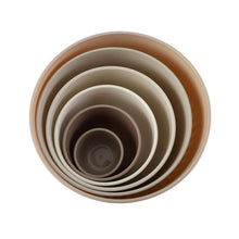 Nesting mixing bowls, off-white ribbed stack viewed from above