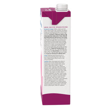 Milk replacer plus liquid bottle, angled view showing rear label text.
