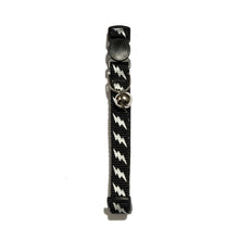 Cat collar vertical view in black with reflective lightning bolts and metal bell