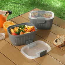 Grey ribbed plastic bento snack containers with clear lids and meal portions