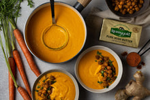 Kerrygold salted pure Irish butter shown in tub with melted butter and herbs