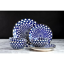Blue ceramic dinnerware set with medallion bowls and plates and gold accents