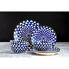 Blue-and-white ceramic bowls and plates with gold-rim accents, stacked