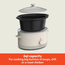 bella slow cooker with open black stoneware insert and clear lid, light base, knob