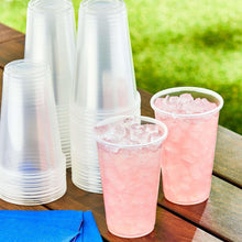 Disposable clear plastic cups with ice, assorted cups on table