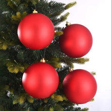 Four matte red shatterproof Christmas ornaments with gold hanging caps