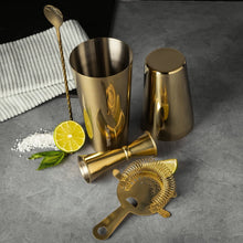 Gold stainless-steel cocktail tools set with cups, bar spoon, shaker, strainer