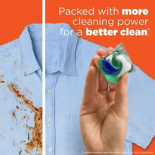Tide PODS Spring Meadow detergent pod in hand, green and blue gel capsule