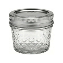 Quilted crystal mason jar with metal lid, clear patterned glass, isolated view