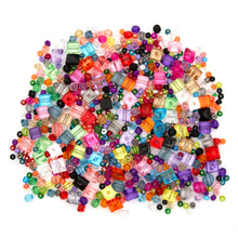 Mixed-color acrylic craft beads scattered in assorted square and round shapes