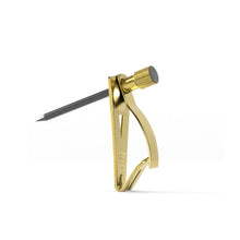 Gold brass picture hanger tool with a black nail and gold base
