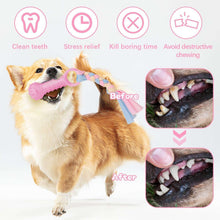 Pink rubber dog chew toy shaped like a bone with ridged grip, held by a dog