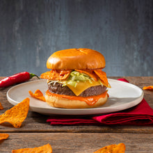 Cheese sandwich on a plate with tortilla chips and a red chili pepper