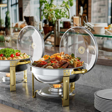 Two stainless chafing dishes with glass lids and gold frames, round food warmers