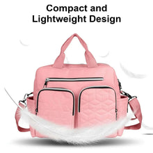 Pink diaper bag tote with quilted front, top zip pocket, and adjustable shoulder straps