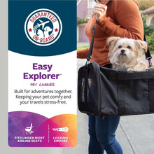 Black pet carrier with shoulder strap and top handle, carrying a small dog