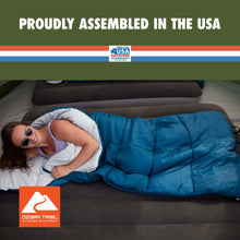 Blue rectangular sleeping bag with white head area, person lying inside.