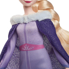 Elsa fashion doll wearing a purple gown with white faux-fur trim and cape sleeves