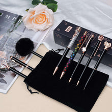 Black pen set with rose-gold details in a fabric storage pouch and box
