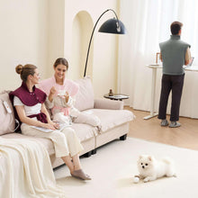 Gray heating pad wrap worn by standing person in a living room