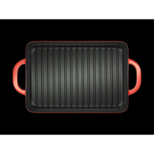 Enameled cast iron grill pan with ridged surface and red loop side handles