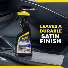 Interior detailer spray bottle with yellow trigger and label, standing on car seats