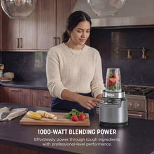 Personal blender with stone silver base and clear blending cup on counter