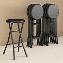 Black vinyl padded stools stacked together, showing round seats and frames