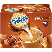 Hazelnut coffee creamer singles box with spoon pour and International Delight logo