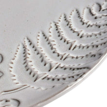Embossed leaf and fern pattern on gray stoneware dinner plate rim