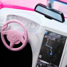 Pink and white toy car interior with steering wheel and dashboard screen