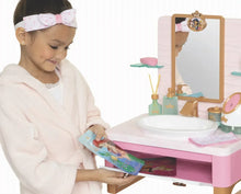 Kids spa play set with child robe, headband, and sink with accessories on counter