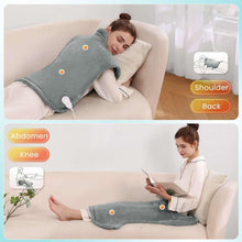 Gray heating pad wrap laid along back and legs on a couch