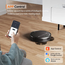 Black robot vacuum on hardwood floor with app control shown by smartphone