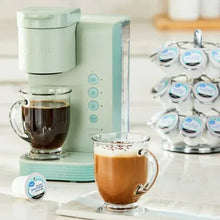 Donut Shop ground coffee pods with glass and pink mugs