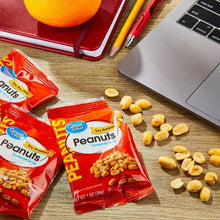 Dry roasted peanuts with sea salt pouches with peanuts scattered on a surface