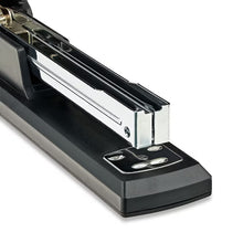 Black desktop stapler close-up, showing staple channel and base