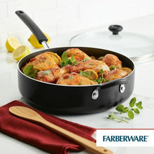 Black nonstick jumbo cooker filled with chicken pieces