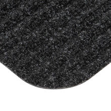 Charcoal tri-rib doormat corner with dense loop pile and curved border edge.