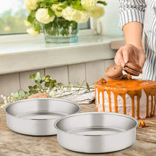 Set of round stainless steel layer cake pans on a kitchen counter