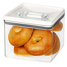 Airtight bagel food storage container with bagels inside, clear walls, white lid, dark blue trim