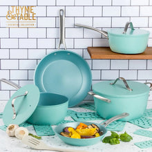 Blue non-stick stock pot and saucepans with lids, with food in pan
