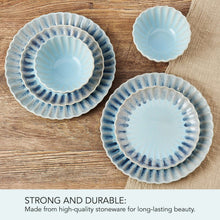 Assorted blue stoneware plates and small bowls with textured scalloped edges