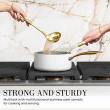 Gold ladle and whisk with white silicone utensil set, stirring a pot